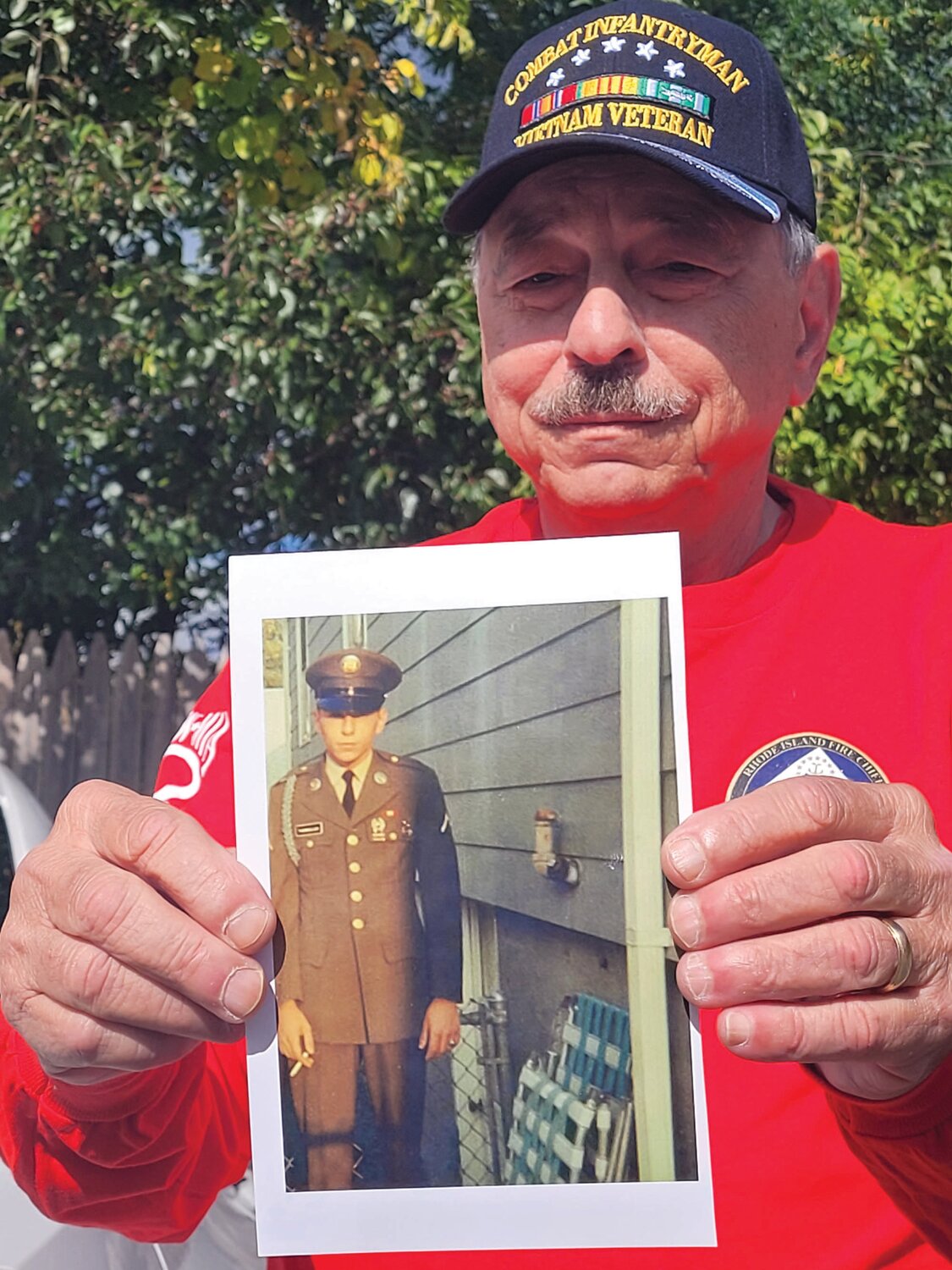 HIS LIST: Retired U.S. Army Sgt. John Tammelleo has a list of lost buddies he wants to look up on the Vietnam Memorial Wall. He plans to find each of the names and make rubbings. Here he holds a photo from his time serving in the infantry during the Vietnam War.